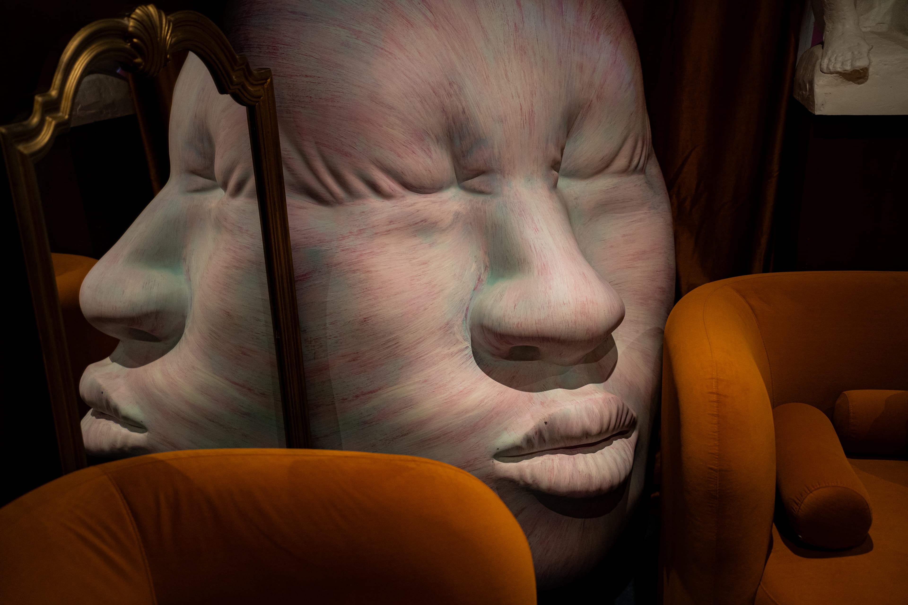 Face sculpture with mirror reflection at RokuNana lounge, Lower East Side NYC