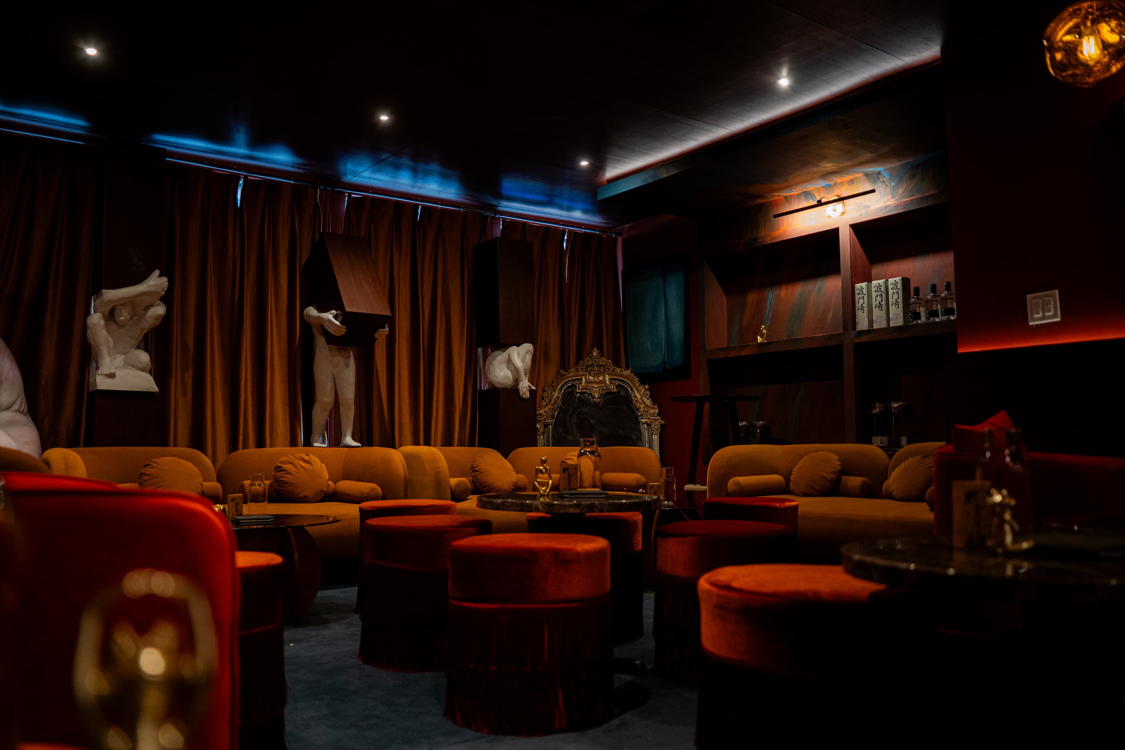 Wide shot of lounge with statues and ambient lighting at RokuNana NYC